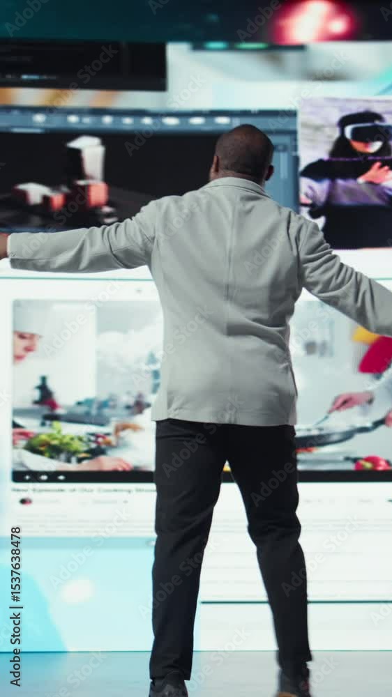 Poster vertical video delighted man entering world of online media, enjoying access to thousands of streami