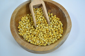 Coriander Seeds in Wood Bowl Isolated, Cilantro Grain, Chinese Parsley Seed Group, Dry Spices, Seasonings, Coriander Herb on White Background 
