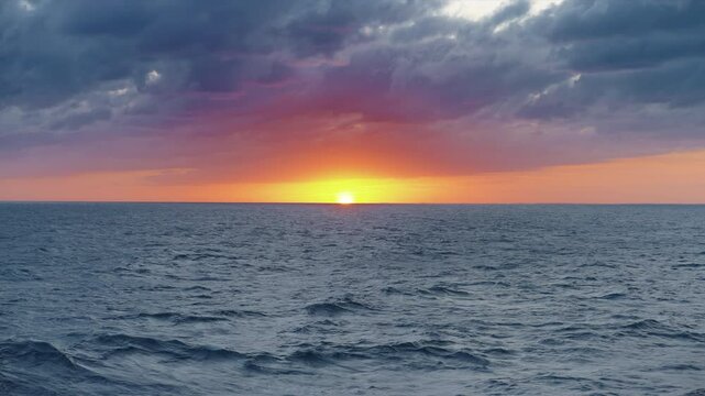 Experience the stunning beauty of a magnificent sunset casting warm hues over calm ocean waters, inspiring nature lovers and travelers to explore new horizons and create unforgettable memories
