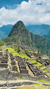 Aerial-style view over ancient Machu Picchu ruins surrounded by lush Andes mountains