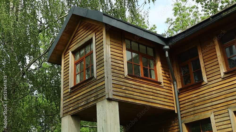 Poster Two rustic wooden structures side by side in a natural setting