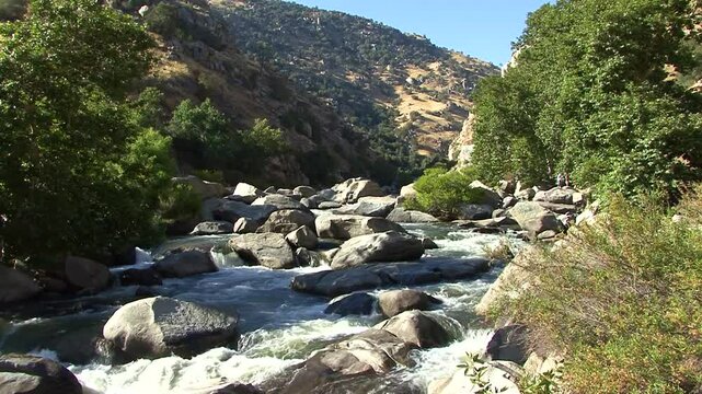 Rapids of the Kern River flow through a bed of massive granite boulders in the lower Kern Canyon of California's majestic southern Sierra Nevada mountains.