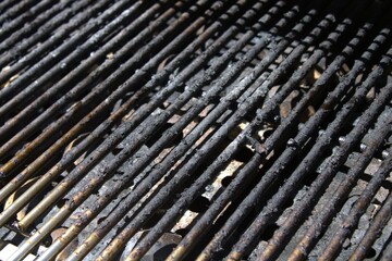 dirty grill bars with charred debris