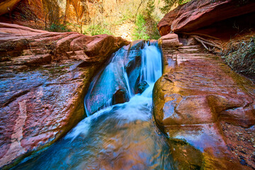 Waterfall Flow Over Red Sandstone Rocks in Kanarra Canyon Close Up Perspective
