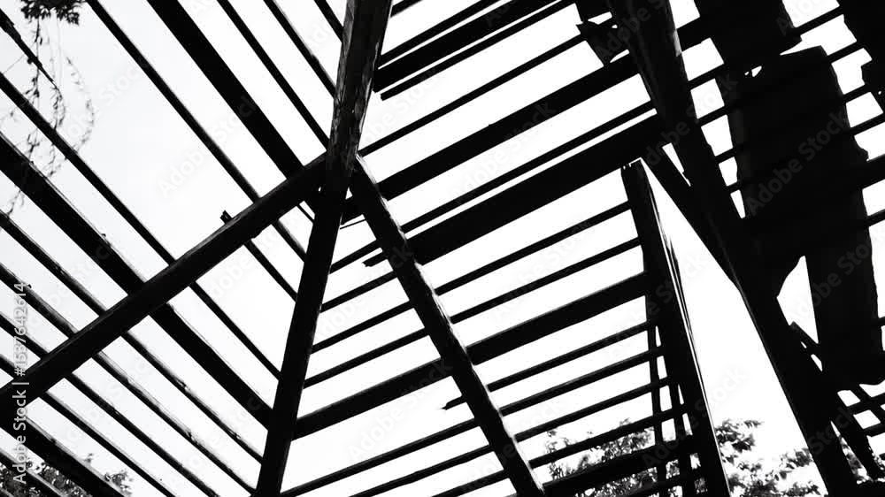 Poster a person standing on a ladder, possibly working or adjusting something