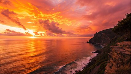 Obraz premium The sun sets over a stunning coastal view, illuminating the cliffs and sea with warm colors, perfect for showcasing natural beauty.