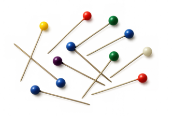 Sewing pins with colorful heads lying on a transparent background, ideal for creative projects or diy activities