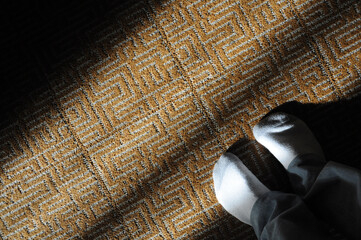 Cozy morning sunlight casts shadows on carpet with warmly sock-covered feet