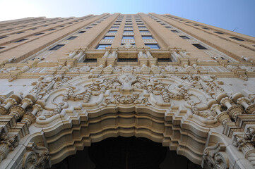 Low-angle view of ornate historic building facade against clear blue sky