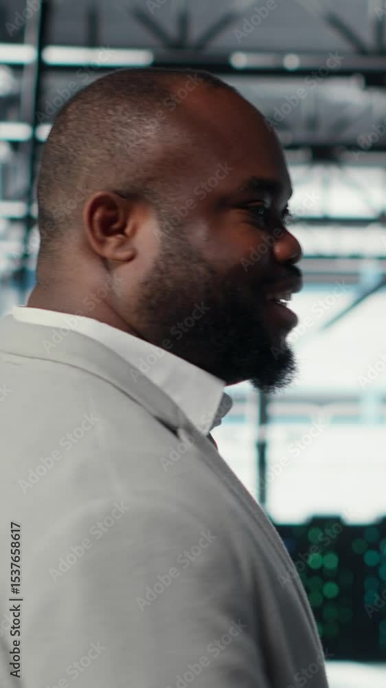 Poster vertical video engineer walking in data center facility, doing inspection on hardware tech handling 