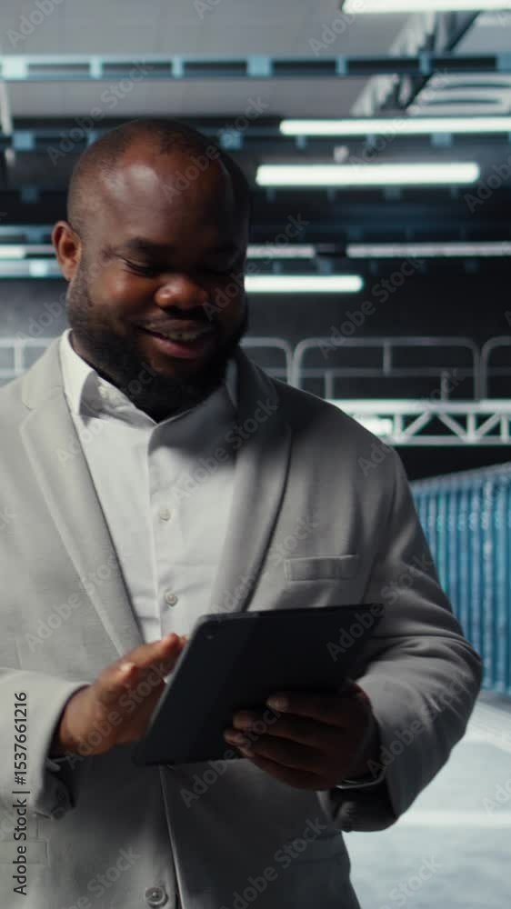 Poster vertical video server room worker troubleshooting server connectivity issues using software on table
