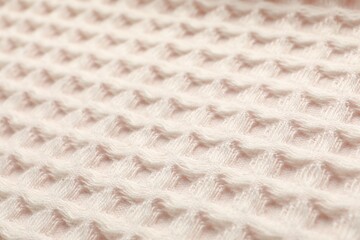 Clean beige waffle towel as background, closeup
