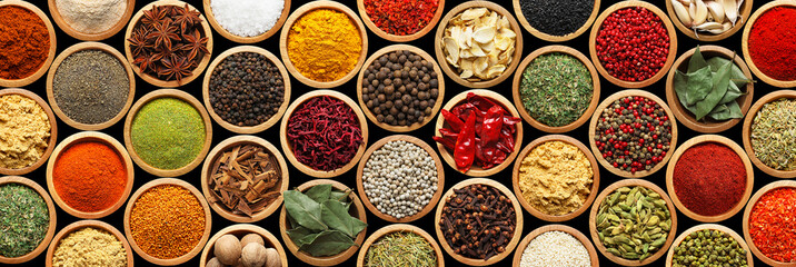 Set of different aromatic spices in bowls on black background, flat lay. Banner design