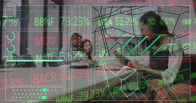 Sitting woman typing on laptop in lounge, with glass partition and data panels, copy space