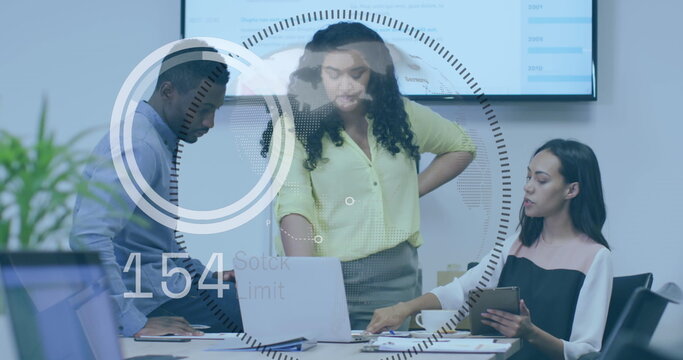 Reviewing data on laptop and tablet in business attire in office conference room with HUD graphics