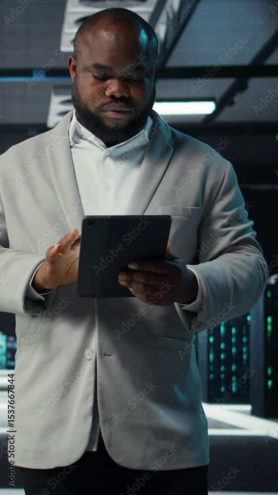 Poster vertical video system administrator walking in data center analyzing infrastructure performance outp