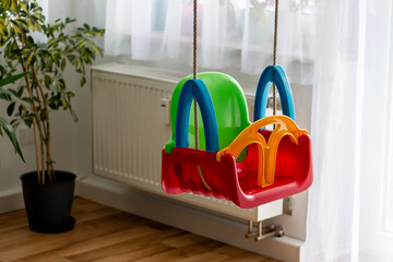 Stylish swing in child's room. Swinging on indoor playground