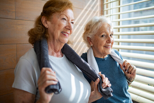 Portrait of a smiling senior lesbian couple after home workout - Powered by Adobe
