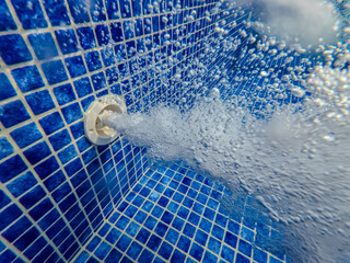 Underwater view of the pool mosaic tile and water jets