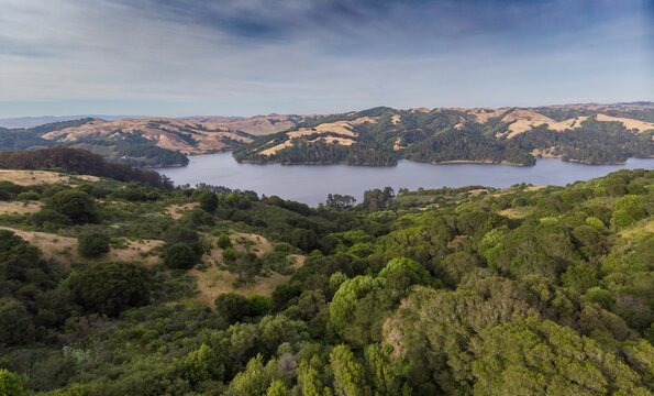 Aerial view of San Pablo Reservoir in Berkeley, California, USA. The reservoir provides drinking water and recreation, surrounded by rolling hills and lush greenery.