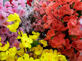 Colorful artificial flowers in vibrant arrangements at a floral market