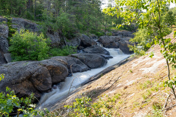 A picturesque view of Victoria Falls along the Black River Road in Washago, Ontario, surrounded by lush greenery and natural beauty.