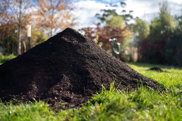 turning a compost pile in a community garden. compost full of microorganisms. sustainable regenerative agriculture