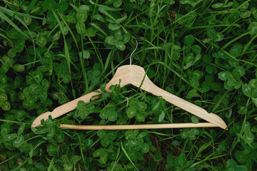 Wooden hanger on green grass background for st. patricks day layout