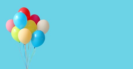 Colorful balloons on blue background with space for text