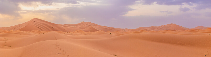 Sunset panoramic landscape views of Erg Chebbi sand dunes located in Morocco on the western edge of the Sahara Desert