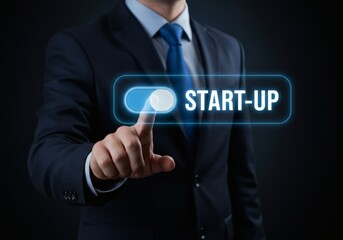 A businessman is shown pressing a digital 'START-UP' switch in a dark, abstract setting, symbolizing the act of starting a new business or project.