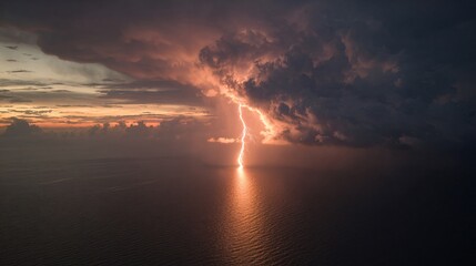 Obraz premium Dramatic Lightning Strike Over Ocean at Twilight, Aerial View