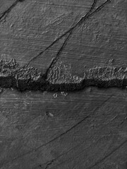 Wall crack texture. Use as a background or wallpaper. Black and white, so contrast and grainy