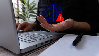 Internet concept. 3D globe icon and warning sign held by a woman with her computer.