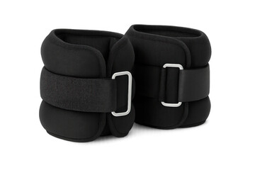 Black ankle weights resting on clear surface, enhancing resistance training and physical therapy effectiveness