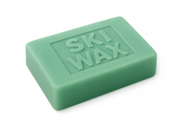 Green ski wax block resting on transparent surface, preparing ski equipment for winter performance
