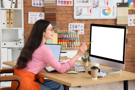 Female designer working with blank computer in office