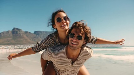 Young man giving woman a joyful piggyback ride on the beach, arms outstretched under the sun, celebrating their carefree summer vacation filled with love and adventure - Powered by Adobe