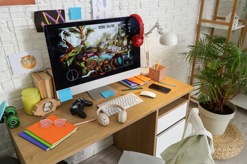 Desk with computer and books in messy children's room