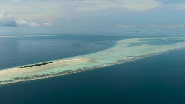 Aerial view of Timba Timba island with beach and coral reef. Tun Sakaran Marine Park. Borneo, Sabah, Malaysia.