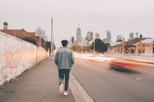 teenager wearing jacket with qr code hurrying through bustling street filled with colorful street graffiti on walls