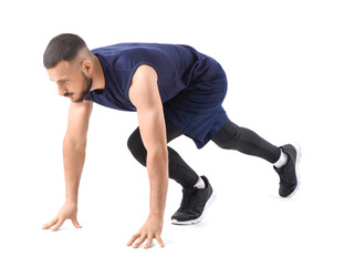 Sporty young man preparing to run marathon on white background