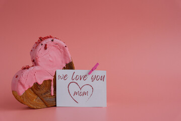 WE LOVE YOU MOM card Mother's Day holiday present Heart shaped strawberry berry croissant on pink...