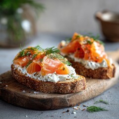Two open-faced toast sandwiches topped with smoked salmon and cream cheese, garnished with fresh dill