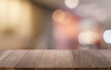 Empty wood table top and blur of restaurant background selective focus product display