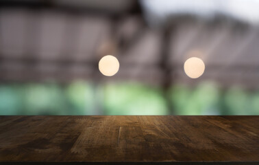 Empty wood table top and blur of restaurant background selective focus product display
