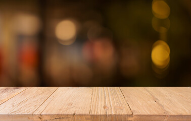 Empty wood table top and blur of restaurant background selective focus product display