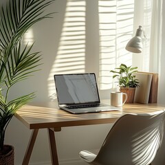 Fototapeta premium Minimalist Scandinavian home office with laptop on wooden desk, coffee mug, indoor plant, cozy chair and white walls, bathed in soft natural daylight, remote work concept with shallow depth of field