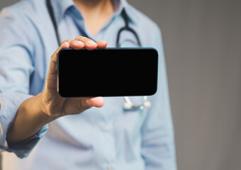 Medical professional holding mobile phone in hand with copy space for telehealth or alerts.