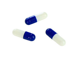 Bulk blue and white capsule pills isolated on white background.
